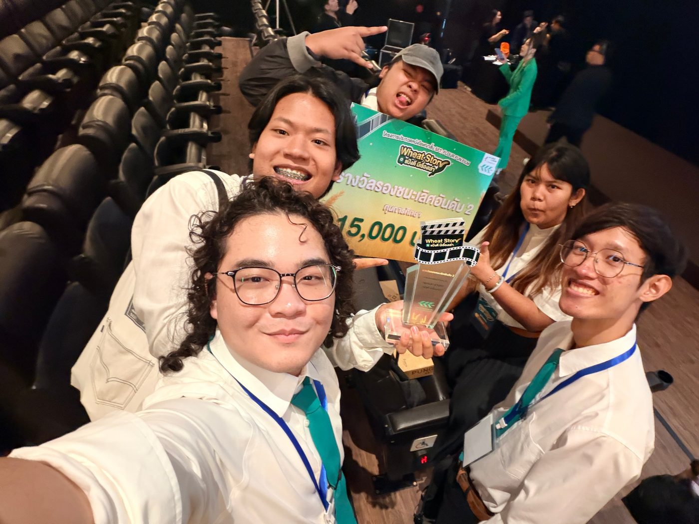 Krit and classmates with a trophy and a 15,000-baht prize board