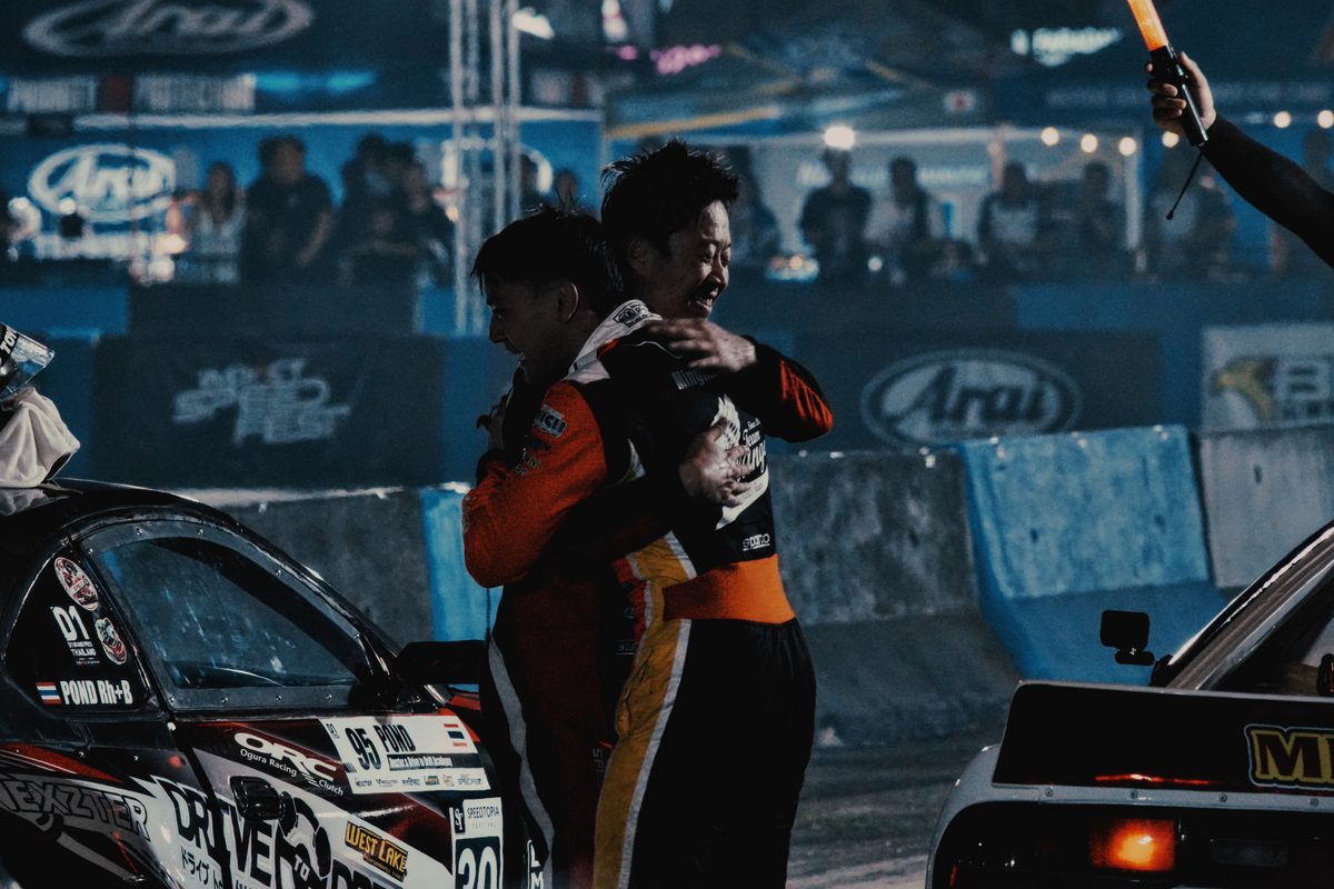 Drivers embracing in the paddock after a run