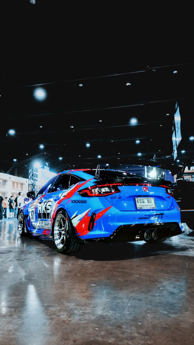 Blue Civic Type R on the show floor under the hall lights